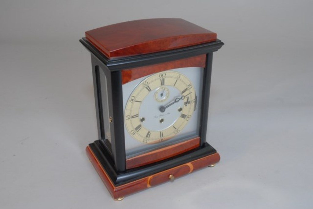 FRANZ HERMIE MANTLE CLOCK: Double dial with second hand dial at 12 o'clock position. With eleven jewels, chimes and wood cased with lower drawer fitted with key. 13 1/4"H X 101/4"W X 7 1/2"D