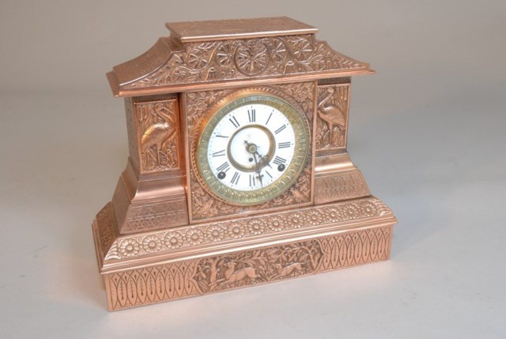 KROEBER MANTLE CLOCK "ARABIA #1": Aesthetic movement mantle clock. Brass with finely cast case with floral and wildlife panels. Enamel dial movement 8 day. Key wind. 13 1/4"H X 16 1/8"W X 5"D