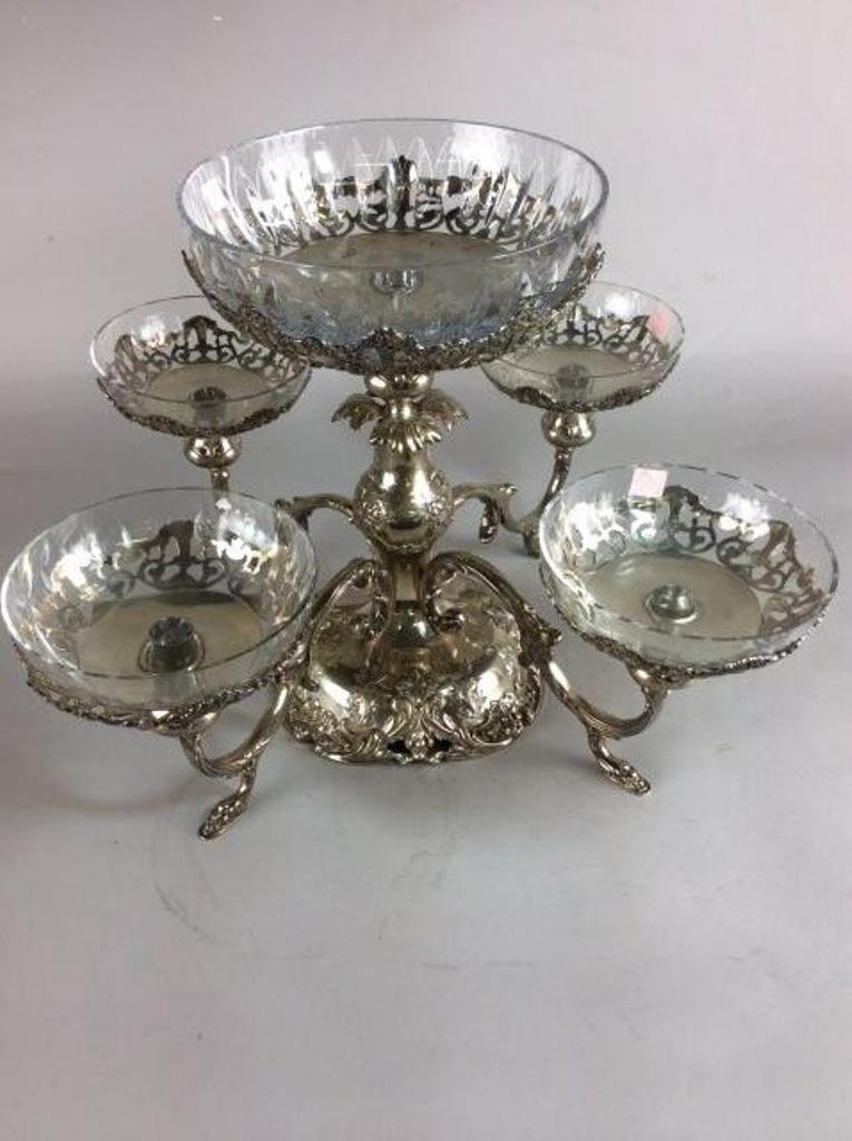 FRANCIS Ist STERLING EPERGNE: Reed & Barton; numbered 5701. The center section crested with a center bowl the base having four emanating scrolled arms with paw foot supports. Each arm ends in a frame wood with crystal bowl insert.