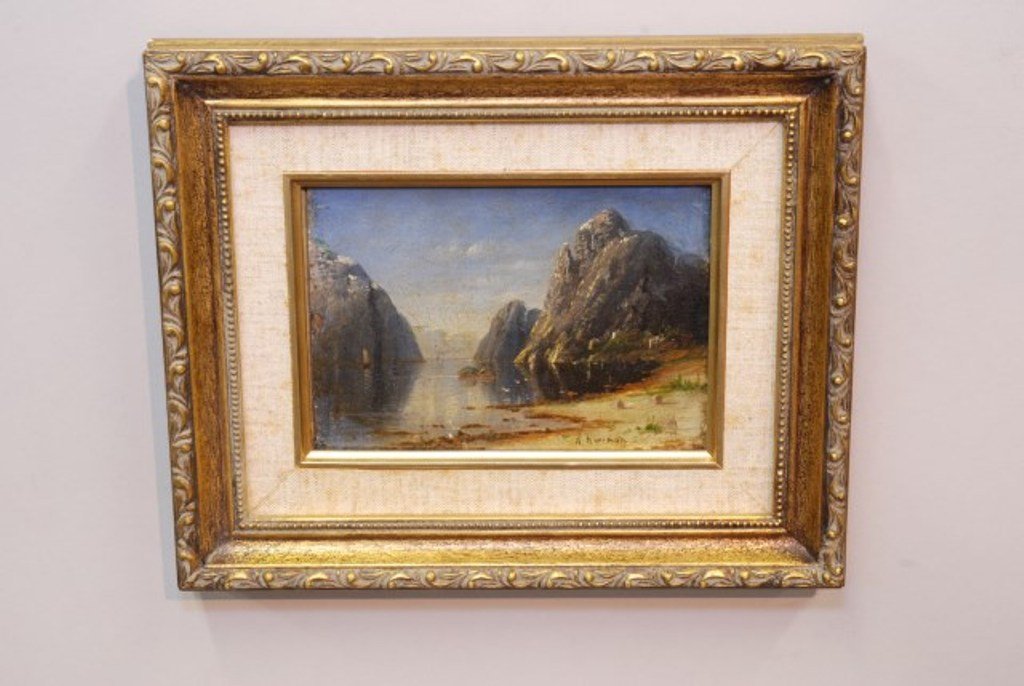 CONTINENTAL SCHOOL (20TH CENTURY): Possibly Italian, Seascape, oil on board, signed illegibly at lower right. The work depicting the form of an Italian fisherman with red cap rowing a boat between towering rock formations. Overall aver