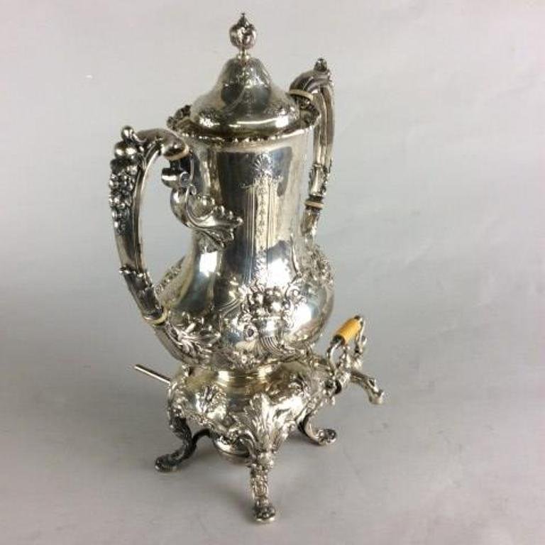 FRANCIS Ist HOT WATER KETTLE ON STAND: Reed & Barton. The twin handled kettle and base having hand chased decoration in the of floral garlands and fruiting cornucopia. Fitted with ivory insulation retaining its original burner. Stamped and