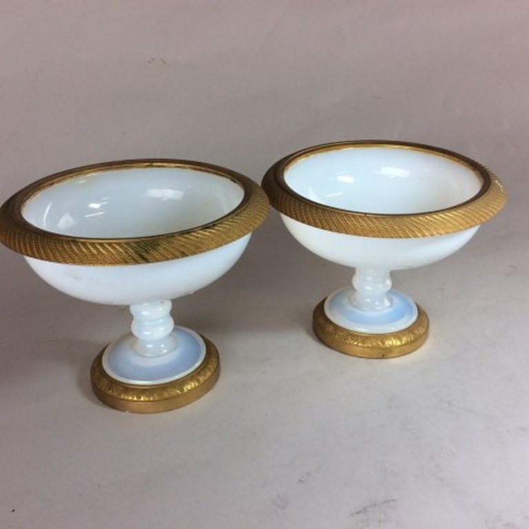 PAIR OPALINE AND BRONZE COMPOTES: The white opaline glass compotes with knopped stems have Empire gilt brown mounted rim and base. 5 1/2"H X 7" Diameter