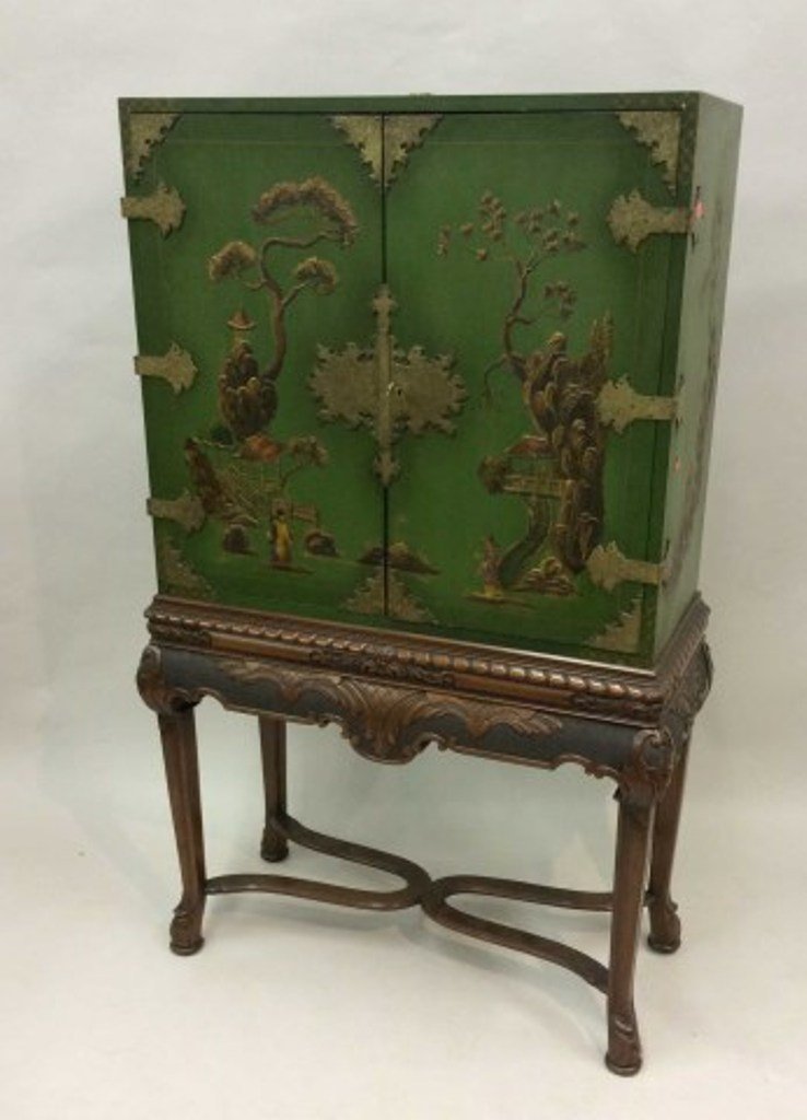 ORIENTAL STYLE SILVER CABINET: The green upper section fitted with a two-door and having chinossirie paint decoration on a carved stretcher base. By Butler Custom furniture 63"H X 30"W X 18/"D