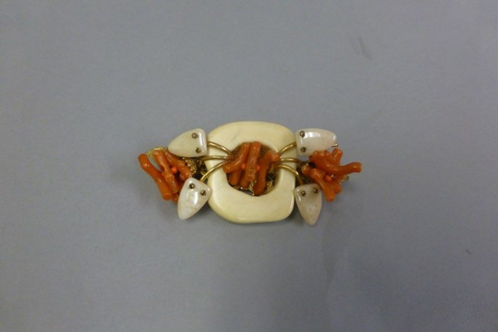 MIRIAM HASKELL DRESS PIN: Costume pin with stylized ivory, coral and pearl.