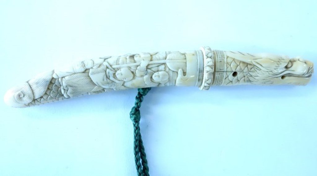 Asian Carved Ivory Dagger: Fine relief carving depicting a court figure and attendants . The blade has a dragon head carved handle. 7 1/4"L