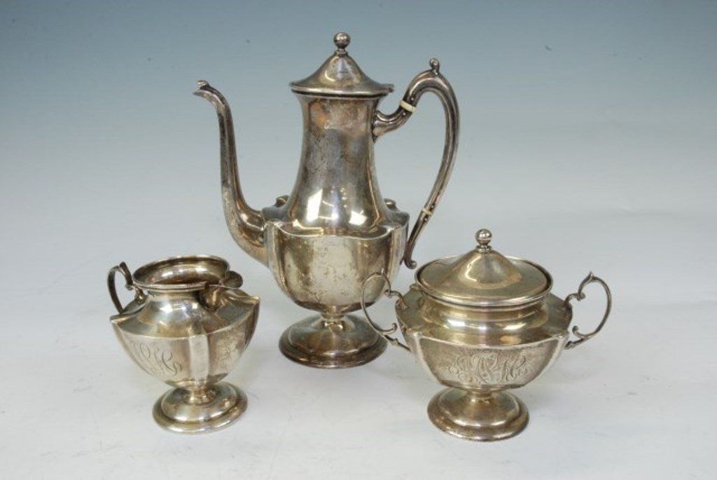 Three Piece Sterling Silver Tea Set: Coffee set with pot, creamer and sugar. Marked sterling and unknown makers mark. Monogrammed Coffee pot 8 1/2" H, Creamer 4 1/2" h and sugar with lid 4" h. Total 20 T. Oz