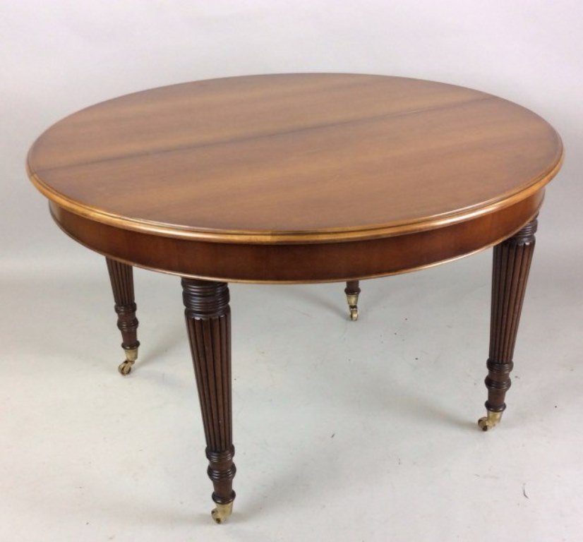 Circular Drum Table with Reed Legs: 20th Century. Manufactured by atrium. The circular top open to hidden extension resting on tapering reeded cylindrical legs with brass capped feet. 48"Diameter X 30"H