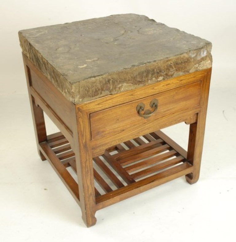 Chinese Imperial City Paving Stone: An ancient Chinese polished square paving stone with rough hewn edges from the "Imperial City". Now resting on a custom Chinese elm wood conforming stand fitted with one long drawer above an open pier