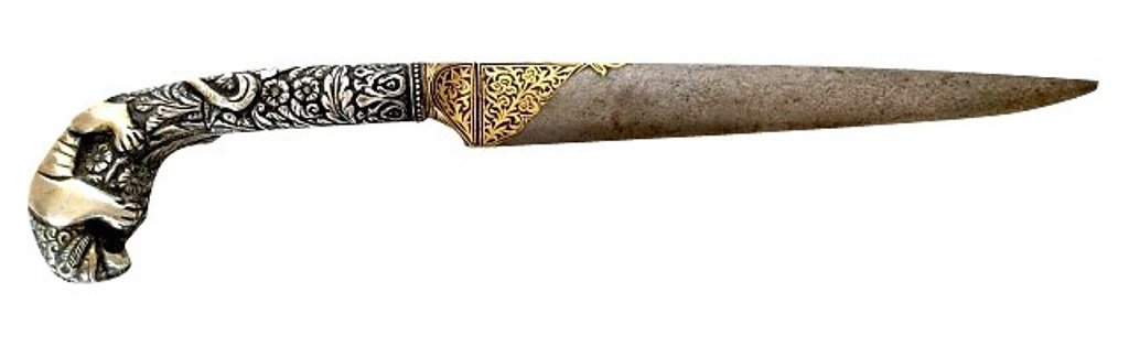 Middle Eastern Dagger: An antique Middle Eastern letter opener having a raised silver curved handle in the form of a crouching lion with floral decoration. The stainless steal blade with gold inlay. 10½" L Provenance: A fi