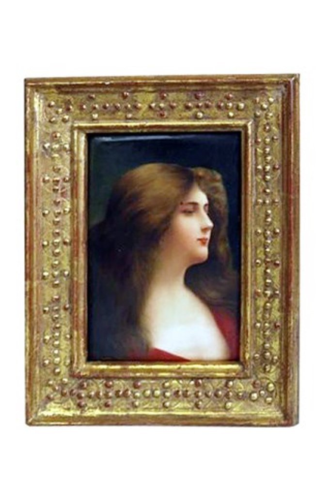 Austrian Porcelain Plaque: An antique Austrian KPM style hand painted porcelain plaque. Depicting a portrait of a young beauty with flowing brown hair dressed in red. Signed lower right Wagner. The back stamped 107 and bears a