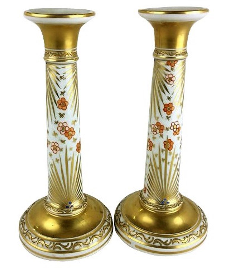 Pair of Meissen Candlesticks: 20th Century Tapering columnar form with stylized fern and floral motif in gilt and paint decoration. Blue under glazed mark with small chip to base of one. 9 1/2" H