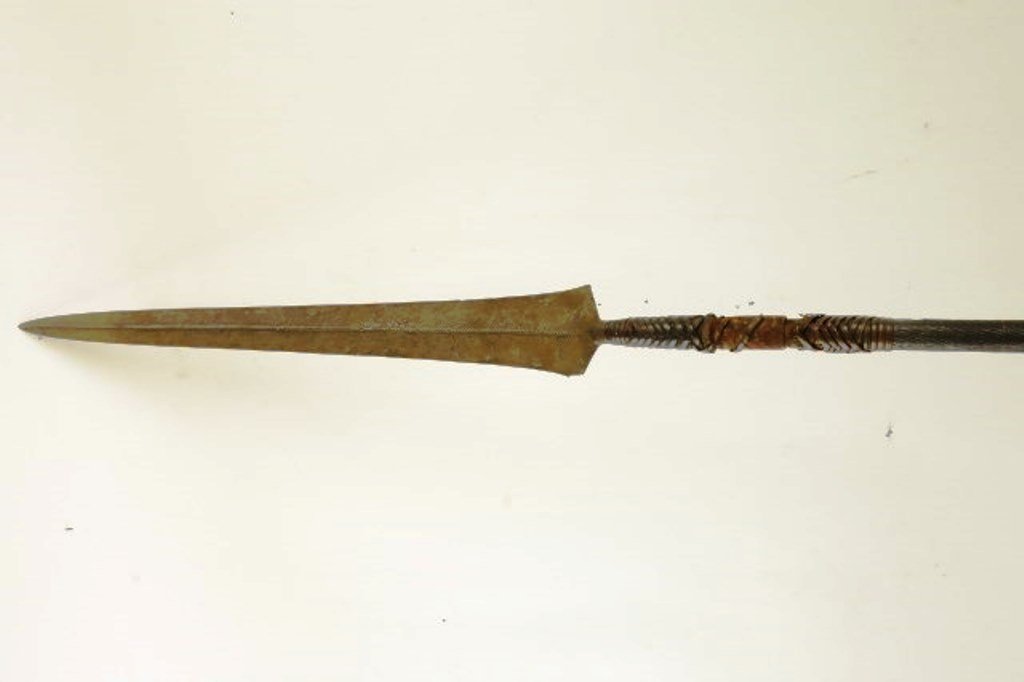 African Spear With Metal Wrapped Handle: Long spear and wrapped metal wood shaft. Overall: 63"L X 2" W Note: Minor loss to metal wrap