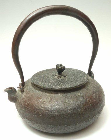 Japanese Iron And Bronze Teapot: Iron teapot with bronze lid. Marked bottom of lid 7 1/2"H with handle, Body 3 1/2"H X 6 3/4" Dia.