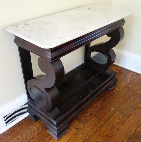 Marble Top Empire Console Table: Mahogany console table with scrolling and mirrored supports. 38"H X 44"W X 21"D