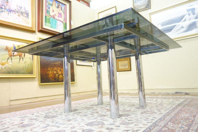 Italian Tobia Scarpa Designed Dining Table: Chromium Steel tube construction with smoked glass top. Tobia Scarpa for Jaume. 26 7/8"H X Top 53 1/4" X 54" Note: Chip to glass corner