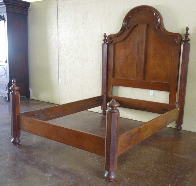 Empire Mahogany Bed With High Arched Headboard: Antique Victorian bed with large headboard. Resting on button feet.Overall: 83"H X 87"L X 64"WNote: Loss to two finials