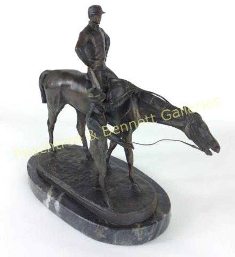 Bronze Jockey: Signed J. Willis Good. Jockey on horseback with attendant in a dark brown patina mounted on a dark marble base. 13"H X 12"L