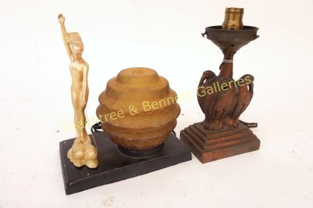 Two Art Deco Lamps: One on tole base with female figure riding dolphins (10.5"H, 10" X 6" base), the other a figural metal lamp depicting four birds on a stepped base (10"H).