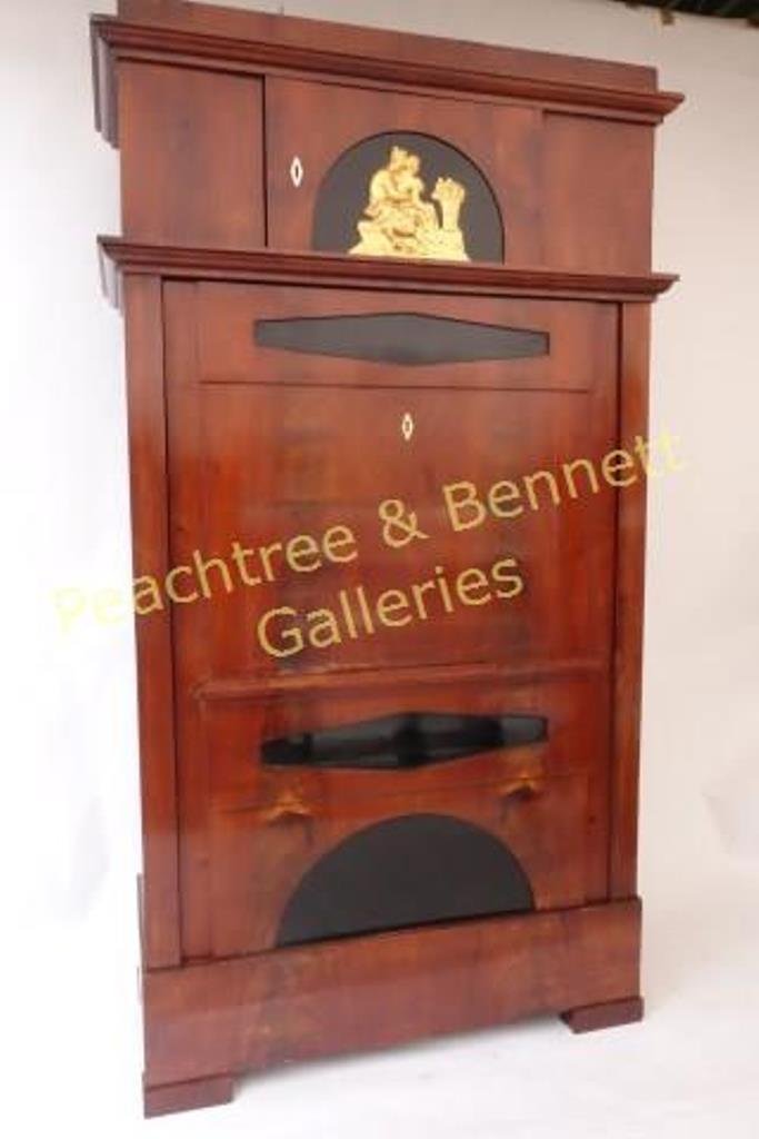 18th C. Biedermeier German Cabinet: Upper door with neoclassical gilt medallion, single large lower door with inset ebonized panels. 83"H X 43"W X 18"D