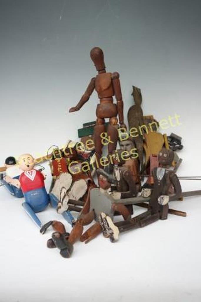 Twelve Dancing Folk Art Dolls: Group of handmade articulated doll figures. 11 wood, one metal. 15" H and less, 5" L and less