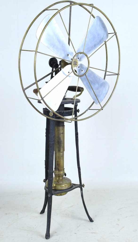 Antique Kerosene Fan: Antique fan which runs on kerosene or similar fuel. Cast iron frame with wood handles having a reservoir marked Favorit Lampe and R Ditmar. Brass guard and metal blade. Untested. 45 inches height, 22
