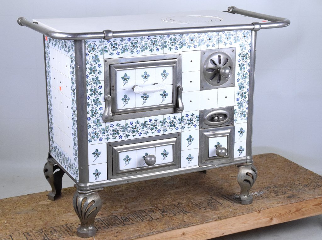 Dutch Amsterdam Tile Stove: Porcelain metal top with single burner and chrome rail having a steel frame with Dutch tiles. The front with two oven compartments left and an air adjustment and compartment right all resting on pierc