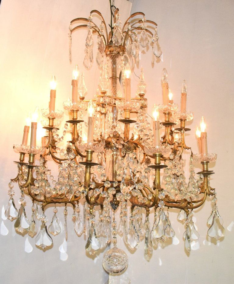 Versailles Palace Chandelier: Versailles Palace crystal and bronze chandelier having two levels of ten lights with bronze arms and center column encapsulated with crystal vase form center with six inch crystal ball at bottom 56 in