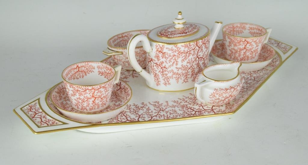 Mintons Bone China Tea Set with Server Tray: Includes serving tray, tea pot, sugar and creamer containers, two saucers, and two cups. Decorated with red tree pattern with gold trim. Serving platter measures 21 inches height, 12 inches width.Vari