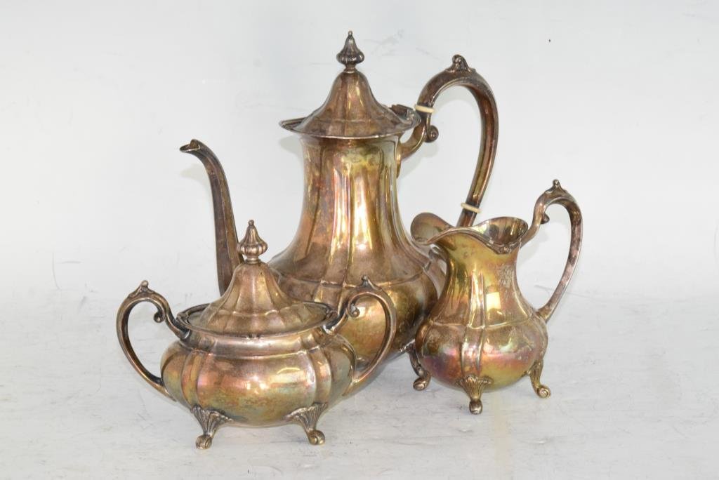 Fisher Silver Co. 3 Pcs Silver Tea Set: Set of 3 footed pieces by Fisher Silver Co. includes teapot with reinforced handle, creamer pitcher, and sugar bowl with lid. Teapot measures 8.75 inches height, 9 inches width, 4.5 inches depth. Crea