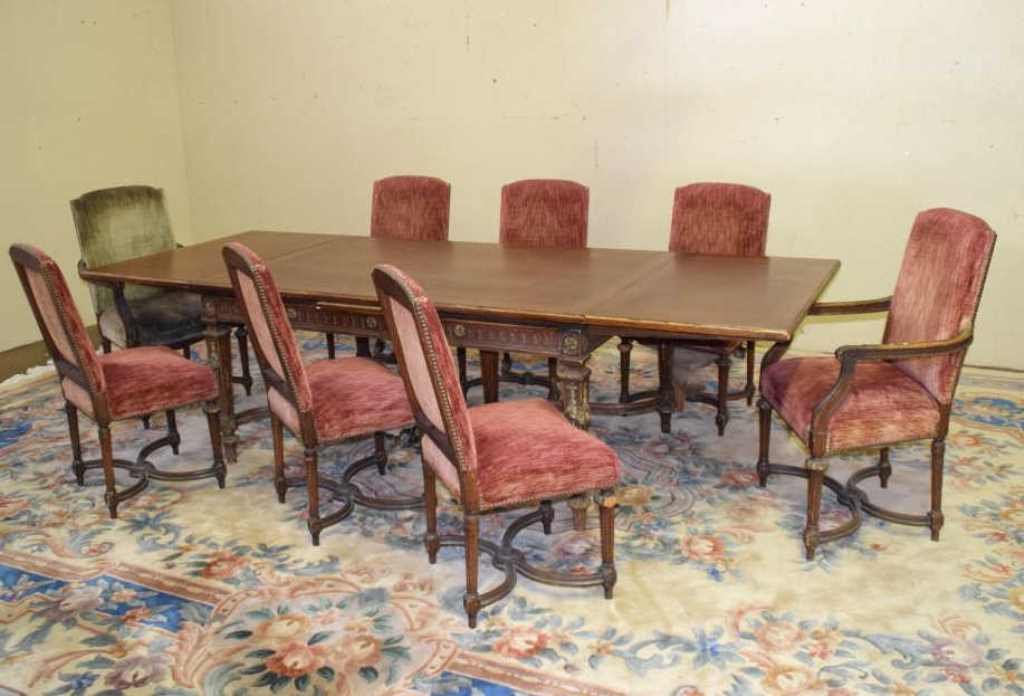 Dining Set, Table and 8 Chairs: Dining table and eight chairs. Two chairs with arms. Chairs and table in a neoclassical style with a floral motif carved on the table. Table measures 30 inches height, 64 inches width, 41.5 inches dep