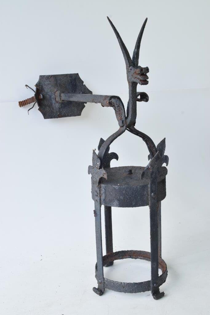 Dragon Head Lantern Sconce: Early black iron lantern having a dragon figure on top on extended arm with round lantern below with fleur de lis decoration height 26 inches, width 9 inches depth 18 inches Note: bend to wall plate,