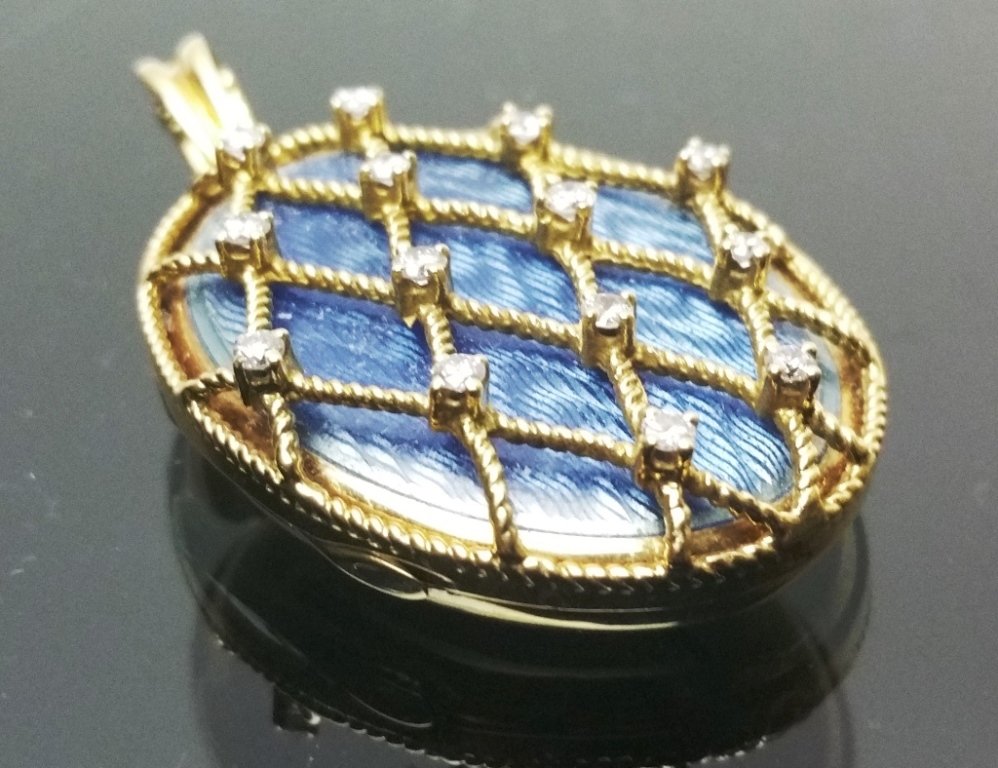 18K Gold, Diamond & Enamel Locket: Oval 18 carat yellow gold frame with a rope twist lattice pattern set with 14 diamonds totaling .85 carats, locket opens to an interior with two photo compartments and has a monogram on the back. Weig