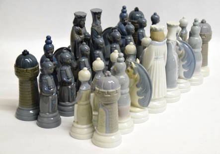 Complete Set 36 Lladro Chess Pieces: Medieval style chess set figurines with all thirty six pieces, all in blue, navy, gray, and white. Discoloration from repair to one white knight, otherwise in good condition. King, largest, measures 7