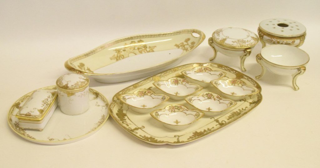 14 Pieces Parcel Gilt Nippon Porcelain: Group 14 pieces of parcel gilt nippon porcelain in 5 distinct patterns all parcel gilt with foliage and floral motifs, group includes 3 tripod dishes, 6 spoon rests, 1 toothpick box, 1 box, and three 