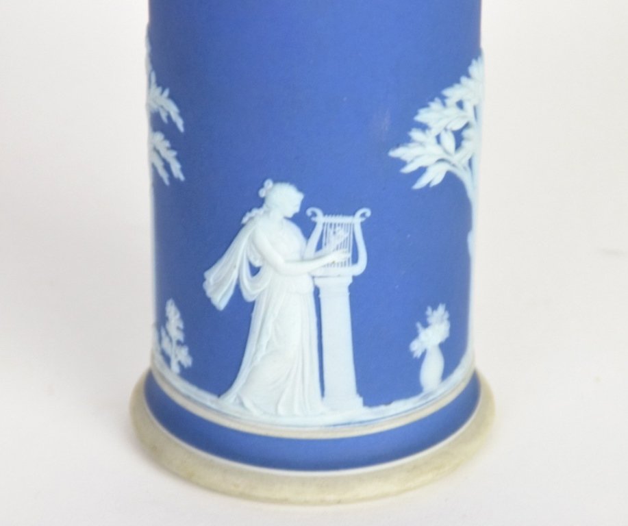 2 Wedgwood Jasper Ware Cylinder Vases: One 19th century with silver plate mount rim, the second dark blue with marks indication 20th century manufacture. Each 8 inches height, 3 inches diameter. 8"H x 3"Dia 8"H x 3"Dia