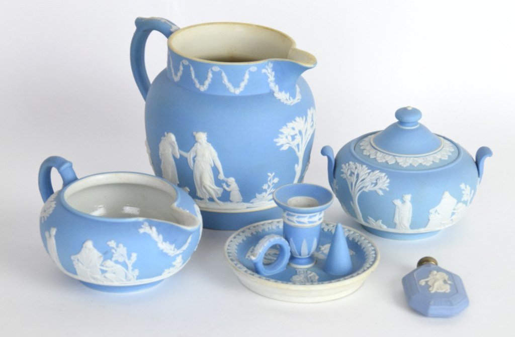 5 Pieces Wedgwood Jasper Ware: 5 pieces of light blue jasper ware, creamer pitcher and sugar bowl with 19th Century marks, larger pitcher, candle holder, and perfume bottle with early 20th century marks. All in good condition. Larg