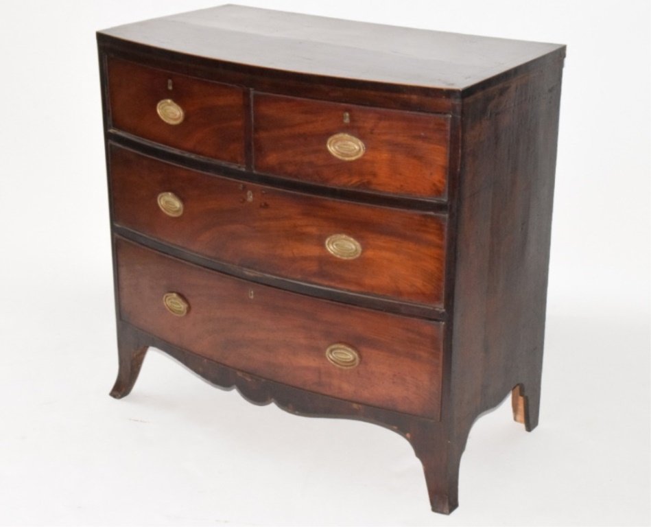 Federal Period Bow Front Chest: Having a four drawer front each fitted with bronze pulls. The name J. H. Elliot on an interior tag. The whole raised on four curved legs and fitted with a carved apron. 33.5 inches height, 34 inches w