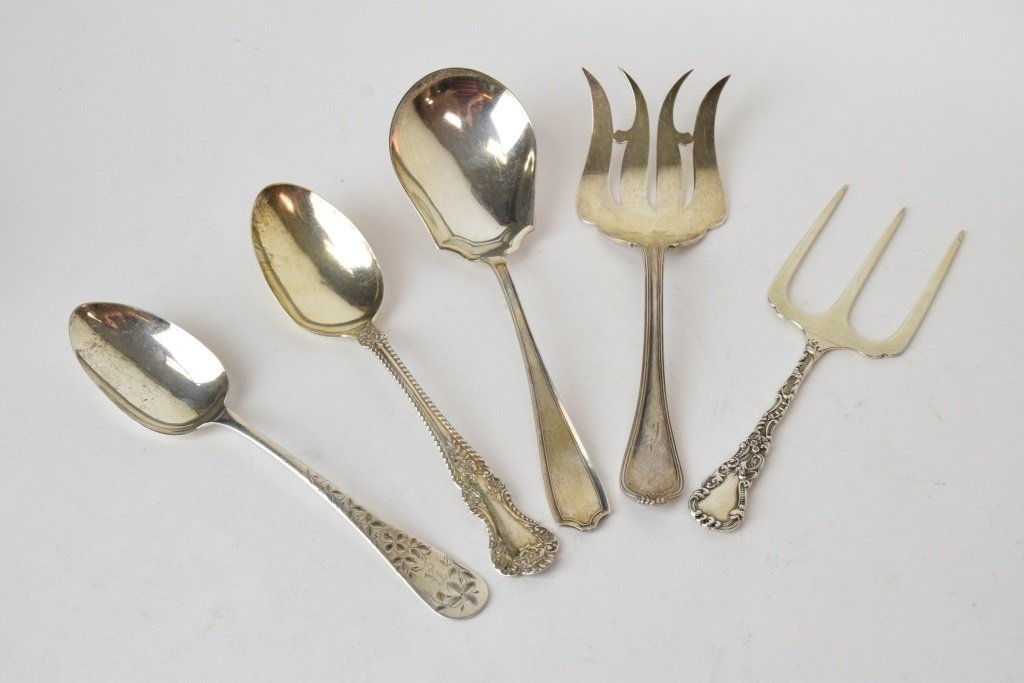 Group 5 Sterling Silver Serveware: Various styles and makers, includes two table spoons, a larger serving spoon, and two serving forks. Makers include early Gorham, Duhme & Co., Alvin Sterling, and M. B. Co. Total weight 12.40 troy oun