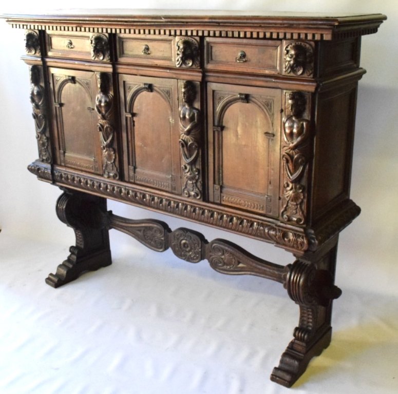 18th C. Italian Walnut Credenza: Having an elongated rectangular top over three short drawer's, above three doors. The drawers are set between lion masks, columns and the doors between columns of semi-nude figures on plinths. The top