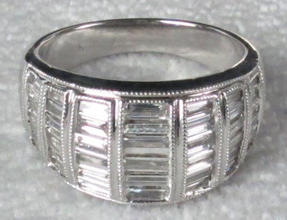 Diamond Band: 14K white gold band boasting 1 ½ carats of G/H color, VS2/SI1 clarity straight baguette diamonds. Measurements: Note: Please carefully read our terms of sale, shipping information, and request any co