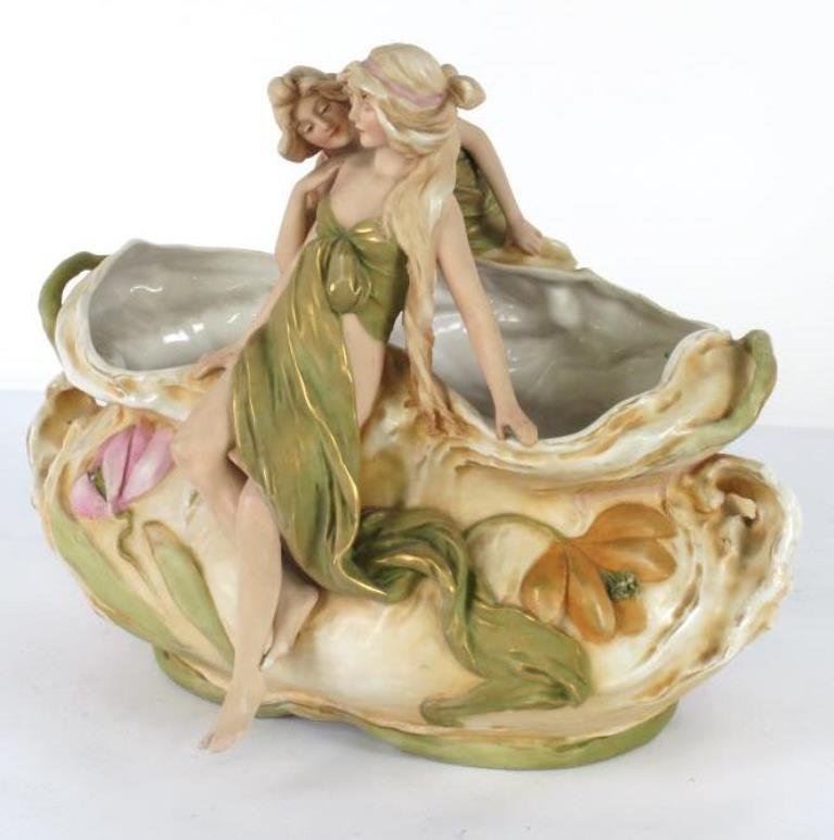 Austrian Nouveau Porcelain Planter Basket: Royal Dux painted and parcel gilt porcelain basket having handle in the form of two partially nude female figures with sides in floral and foliage form. 12.25 inches height, 15 inches width, 10 inches