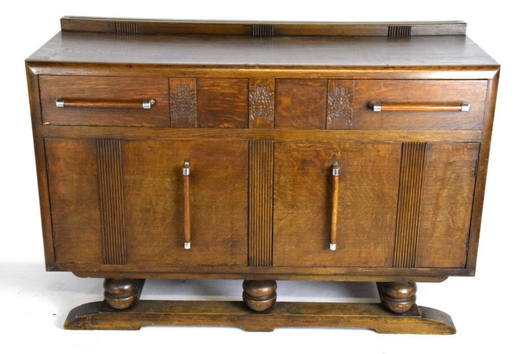 Carved Dark Oak Sideboard: Having two deep top drawers carved with foliage motif panels over two cabinets, raised on three spherical feet and two straight back legs. 37.25 inche sheight, 54 inches width, 20 inches depth. 37.25"