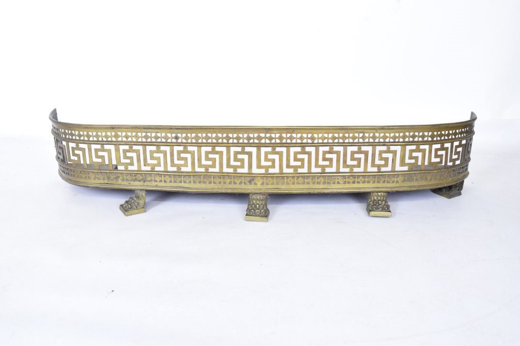 Anitque Bronze Fire Fender: Bronze fire fender having reticulated form with a band in a greek key meander between two reticulated foliate motif bands, raised on five claw feet. 9 inches height, 49 inches width, 12 inches depth. 