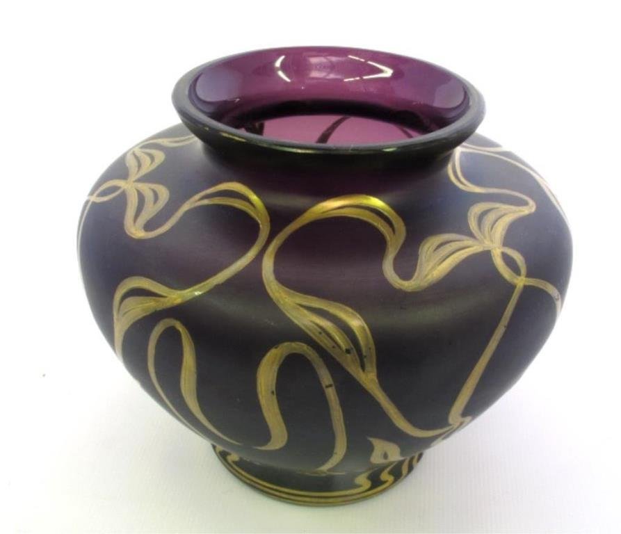 Loetz Glass Vase: Art Glass vase in purple tone glass with gilt painted overlay in a stylized vine motif. Signed "A. Rub" on underside. 4.25 inches height, 5 inches diameter. 4.25"H x 5"Dia. Good. 4.25"H x 5"Dia.
