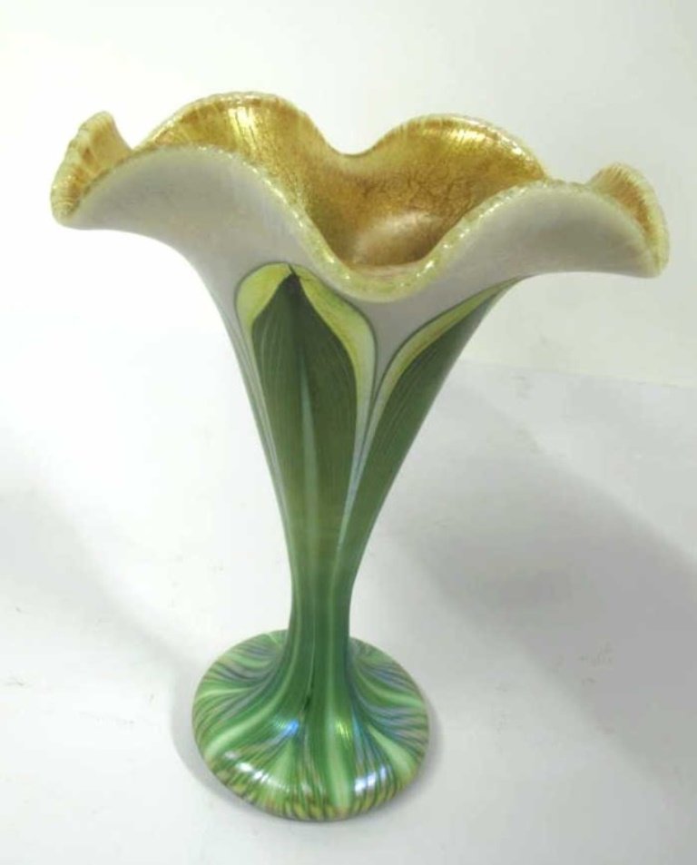 Quezal Iridescent Trumpet Vase: Floral form trumpet vase in pulled leaf pattern with gilt crackle interior. 6.5 inches height, 5 inches diameter. 6.5"H x 5"Dia Good.