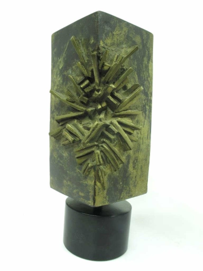 Feliciano Signed Bronze Sculpture: Rectangular bronze sculpture with an impact or explosion design. Mounted onto an ebonized wood base. Signed "FELICIANO" near base. 11.25 inches height, 3.75 inches square. 11.25"H x 3.75"W x 3.75"D Go