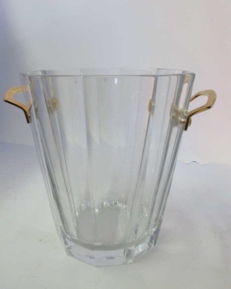 Baccarat Crystal Champagne Bucket: Baccarat crystal ice bucket having brass mount handles and marked on underside with etched, circular "Baccarat France" mark. 9 inches height, 10 inches width, 7.75 inches depth. . 9"H x 10"W x 7.75"D 