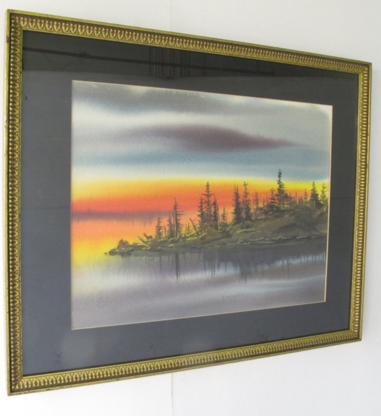 Hurb Hultgren (1924-2009) Watercolor on Paper: Watercolor on paper signed Hultgren to lower center and titled "Sundown, Kabetogama." Depicting a vibrant sunset behind a forested peninsula with a buck in silhouette. Housed in a carved gilt wood fra