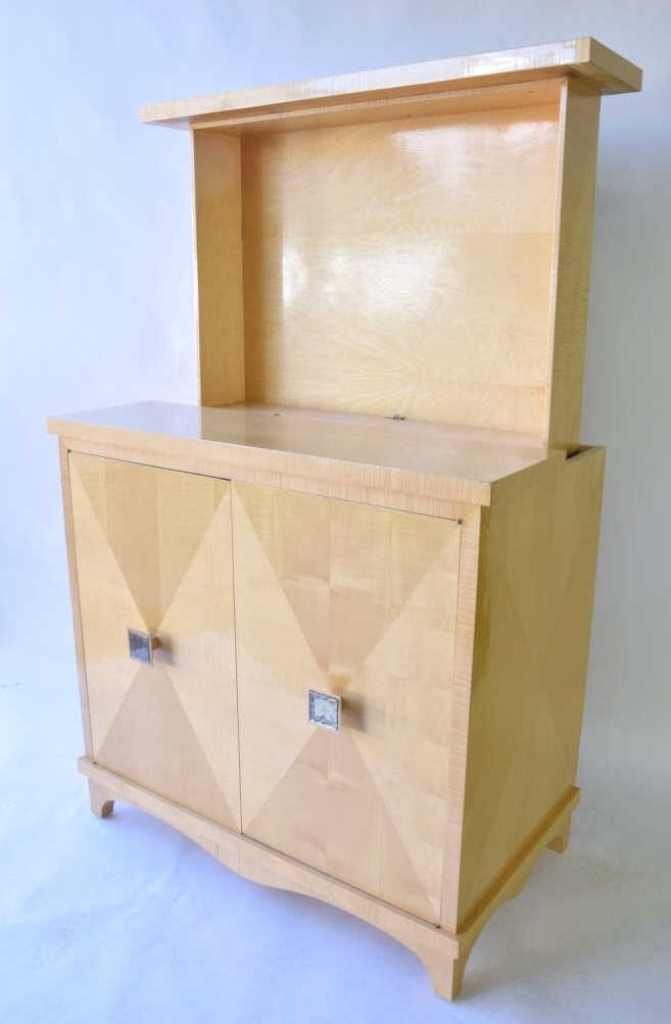 Modern Entertainment Cabinet: Contemporary light wood with lacquer finish cabinet having two door bottom with interior shelves and drawers and top motorized hide-a -away TV area will accept up to 32" diagonal flat screen height 40