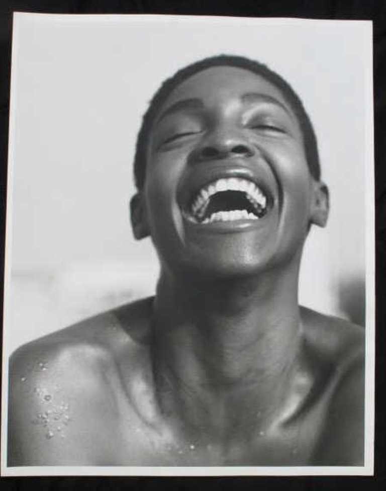Baryta Paper Print by Michel Comte: Black and white photographic print on baryta paper by Michel Comte. Depicting a laughing woman's face in motion. Artist's marks in pencil to verso. 20 inches height and 16 inches width. 20"H x 16"W x